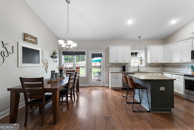 521 Peeples Valley Rd NW, Cartersville, GA 30121 - kitchen with stainless steel appliances, lofted ceiling, a chandelier, decorative backsplash, and a center island