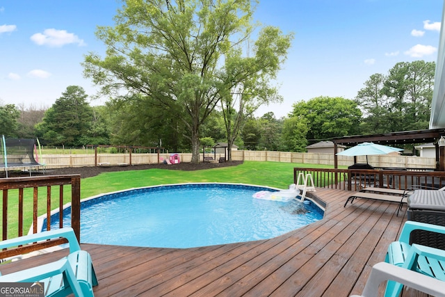 521 Peeples Valley Rd NW, Cartersville, GA 30121 - view of pool with a trampoline, a wooden deck, a fenced backyard, and view of scattered trees