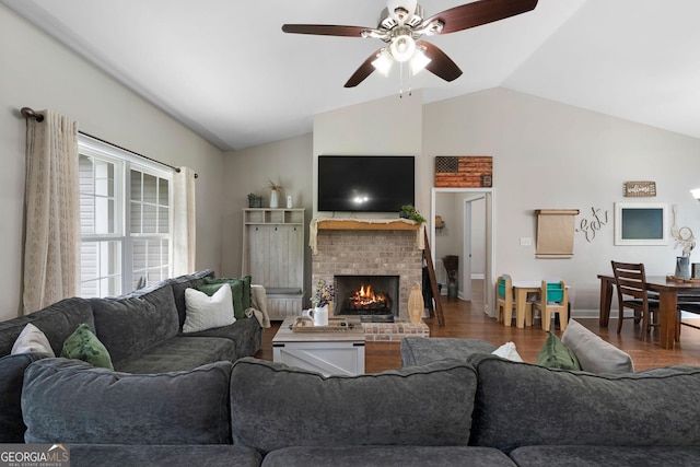 521 Peeples Valley Rd NW, Cartersville, GA 30121 - living area featuring a brick fireplace, wood finished floors, a ceiling fan, and high vaulted ceiling