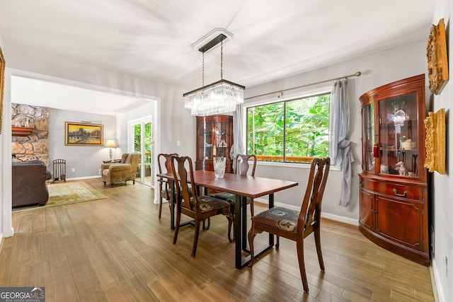 4290 Inverness Ct NE, Roswell, GA 30075 - dining space featuring plenty of natural light, a chandelier, and wood finished floors