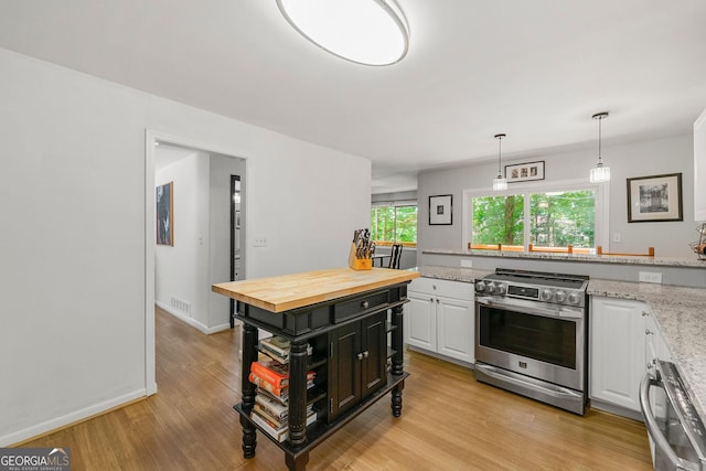 4290 Inverness Ct NE, Roswell, GA 30075 - kitchen with stainless steel range, wood counters, white cabinets, light wood-style floors, and pendant lighting