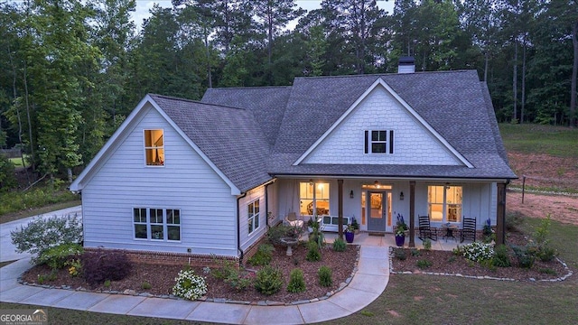 1069 Dean Hill Rd, Monroe, GA 30655 - view of front of property with a chimney, a porch, a shingled roof, and board and batten siding
