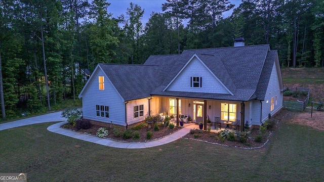 1069 Dean Hill Rd, Monroe, GA 30655 - view of front of home featuring a front yard, a chimney, a shingled roof, and board and batten siding