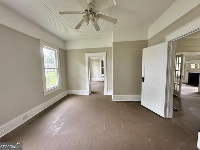 310 Butler St, Waycross, GA 31501 - spare room featuring ceiling fan and dark wood-type flooring
