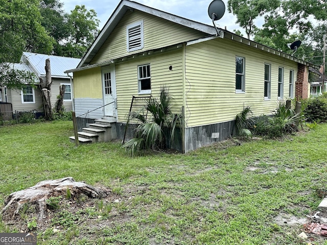 310 Butler St, Waycross, GA 31501 - back of house featuring a lawn