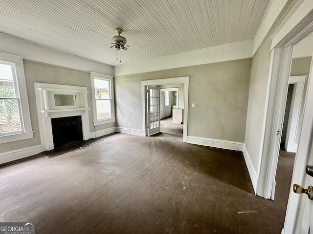 310 Butler St, Waycross, GA 31501 - unfurnished living room featuring hardwood / wood-style flooring, a fireplace with raised hearth, and ceiling fan