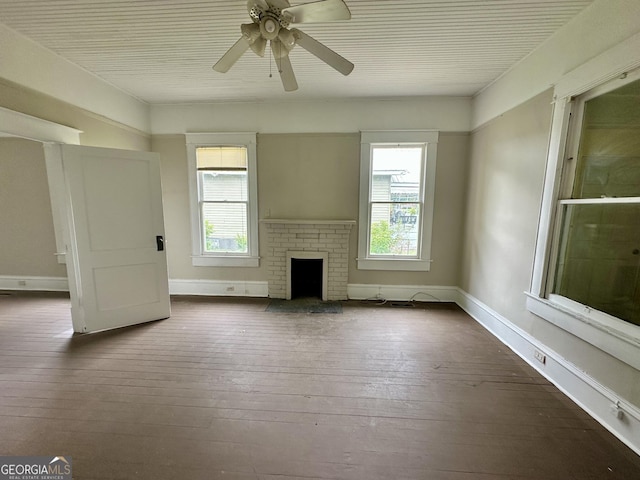 310 Butler St, Waycross, GA 31501 - unfurnished living room with dark wood-type flooring, ceiling fan, and a brick fireplace