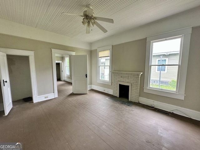 310 Butler St, Waycross, GA 31501 - unfurnished living room featuring a ceiling fan, a brick fireplace, and hardwood / wood-style flooring