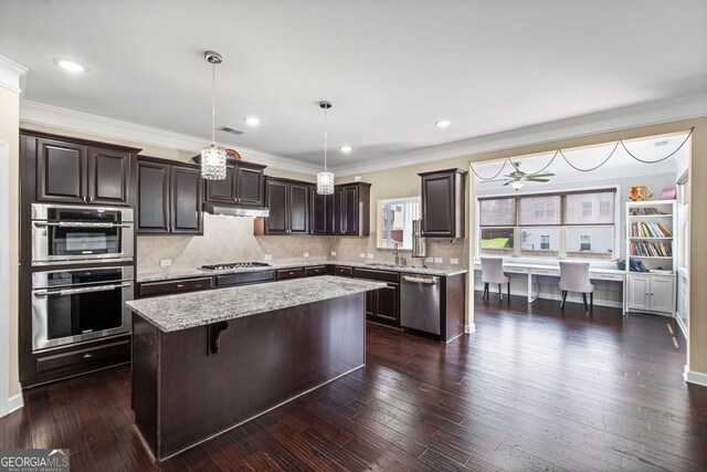 745 Newfield Ln, Alpharetta, GA 30004 - kitchen featuring appliances with stainless steel finishes, dark brown cabinetry, a kitchen island, under cabinet range hood, and tasteful backsplash