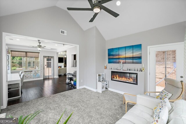 745 Newfield Ln, Alpharetta, GA 30004 - carpeted living room with ceiling fan, a glass covered fireplace, high vaulted ceiling, wood finished floors, and recessed lighting