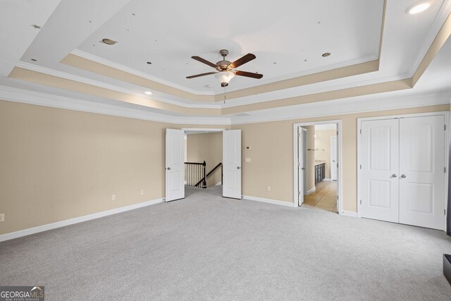 745 Newfield Ln, Alpharetta, GA 30004 - unfurnished bedroom featuring a tray ceiling, light carpet, crown molding, recessed lighting, and a ceiling fan