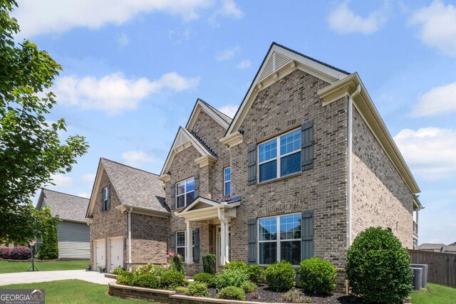 745 Newfield Ln, Alpharetta, GA 30004 - view of front facade featuring brick siding, driveway, a garage, and a shingled roof