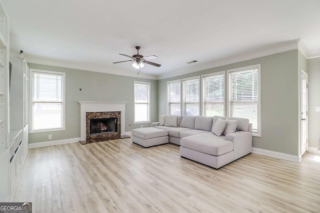 95 Jeffco Dr, Jefferson, GA 30549 - living area with crown molding, ceiling fan, light wood-style floors, and a premium fireplace