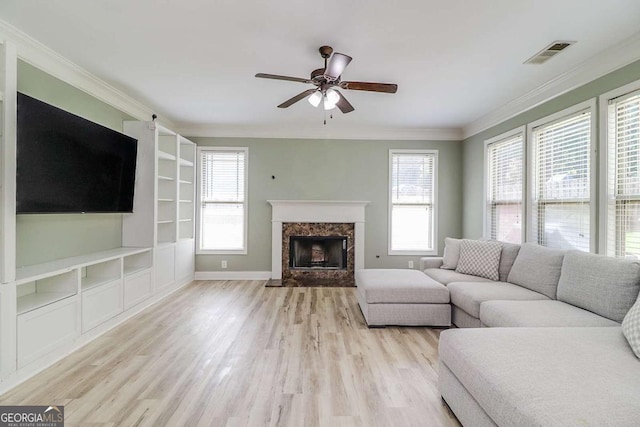 95 Jeffco Dr, Jefferson, GA 30549 - living area with wood finished floors, a ceiling fan, crown molding, a high end fireplace, and built in features