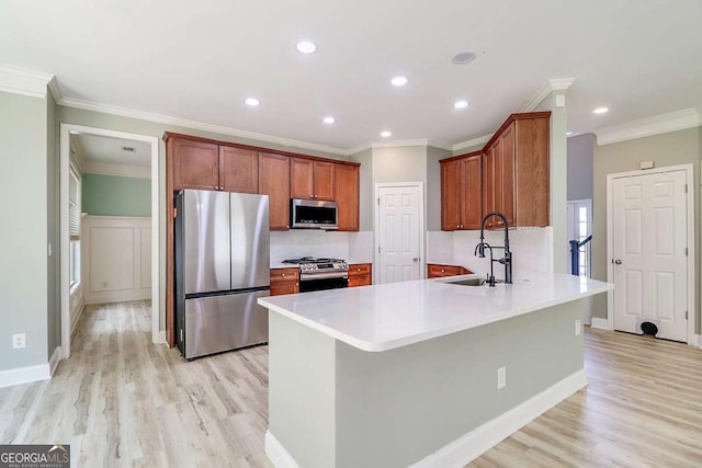 95 Jeffco Dr, Jefferson, GA 30549 - kitchen with stainless steel appliances, light wood finished floors, recessed lighting, a peninsula, and ornamental molding