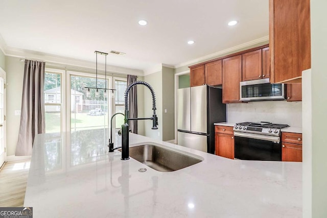 95 Jeffco Dr, Jefferson, GA 30549 - kitchen featuring stainless steel appliances, ornamental molding, brown cabinetry, recessed lighting, and light stone counters