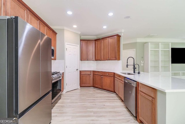 95 Jeffco Dr, Jefferson, GA 30549 - kitchen with stainless steel appliances, a peninsula, crown molding, recessed lighting, and light wood finished floors