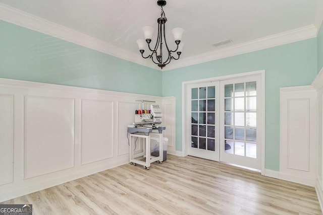 95 Jeffco Dr, Jefferson, GA 30549 - dining room featuring french doors, ornamental molding, light wood finished floors, a chandelier, and a decorative wall