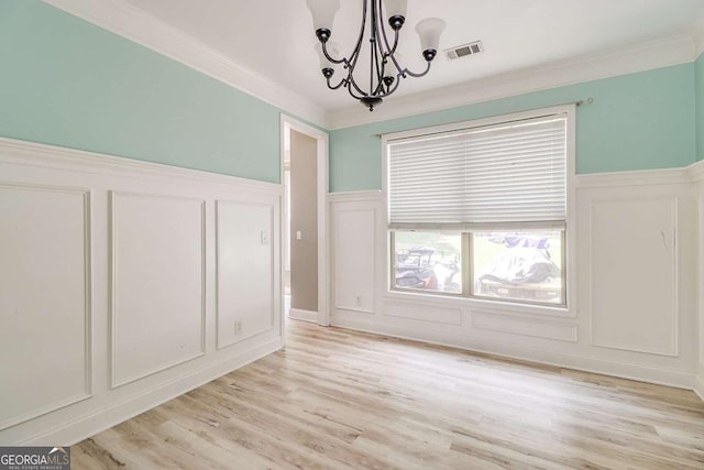 95 Jeffco Dr, Jefferson, GA 30549 - unfurnished dining area featuring a decorative wall, a chandelier, light wood finished floors, ornamental molding, and wainscoting