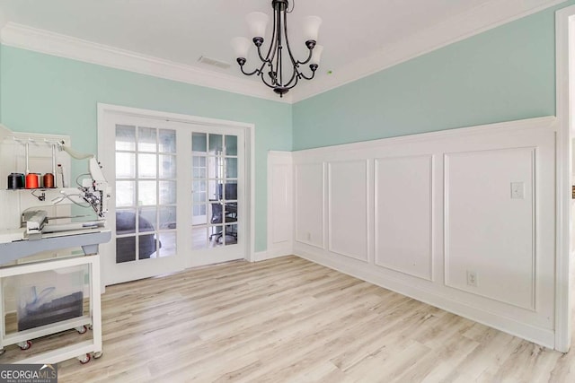 95 Jeffco Dr, Jefferson, GA 30549 - unfurnished dining area featuring crown molding, light wood-style flooring, and a chandelier