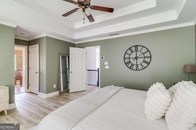 95 Jeffco Dr, Jefferson, GA 30549 - bedroom featuring a raised ceiling, wood finished floors, crown molding, ensuite bathroom, and ceiling fan