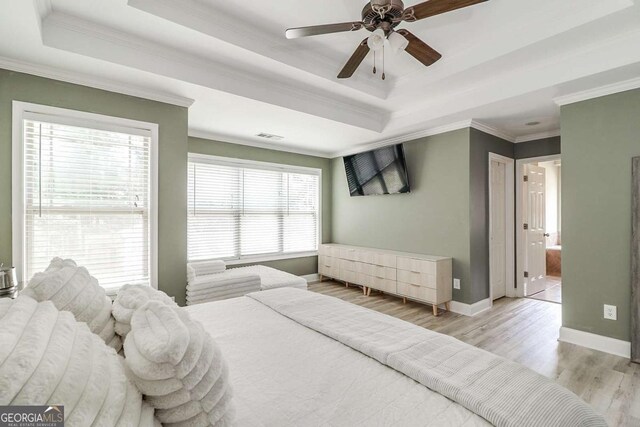 95 Jeffco Dr, Jefferson, GA 30549 - bedroom featuring a tray ceiling, light wood-type flooring, crown molding, and ensuite bathroom