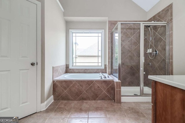 95 Jeffco Dr, Jefferson, GA 30549 - full bath with a garden tub, a shower stall, tile patterned floors, vanity, and lofted ceiling