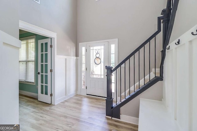 95 Jeffco Dr, Jefferson, GA 30549 - foyer entrance featuring wood finished floors, stairs, and a towering ceiling