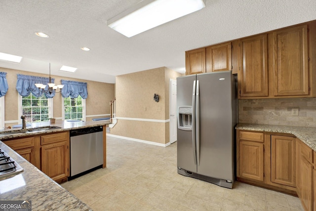 4313 Deep Springs Ct NW, Kennesaw, GA 30144 - kitchen featuring appliances with stainless steel finishes, a chandelier, brown cabinets, a textured ceiling, and recessed lighting