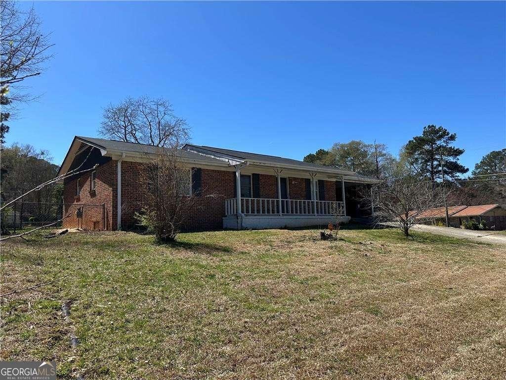 726 Shoreline Trl SE, Conyers, GA 30094 - ranch-style house featuring a front lawn, brick siding, and a porch