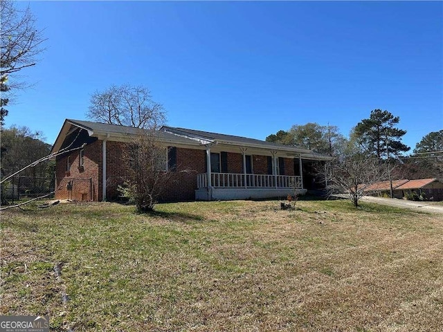 726 Shoreline Trl SE, Conyers, GA 30094 - ranch-style house featuring a front lawn, brick siding, and a porch
