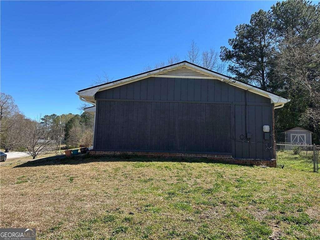 726 Shoreline Trl SE, Conyers, GA 30094 - view of side of property featuring an outdoor structure