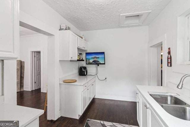 1192 Arlington Ave SW, Atlanta, GA 30310 - kitchen featuring a sink, dark wood-style floors, white cabinetry, light countertops, and a textured ceiling