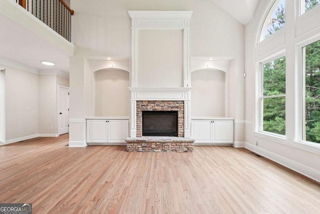 4508 Meadow Vista Trce, Lithonia, GA 30038 - unfurnished living room with healthy amount of natural light, high vaulted ceiling, light wood-style floors, a fireplace, and baseboards