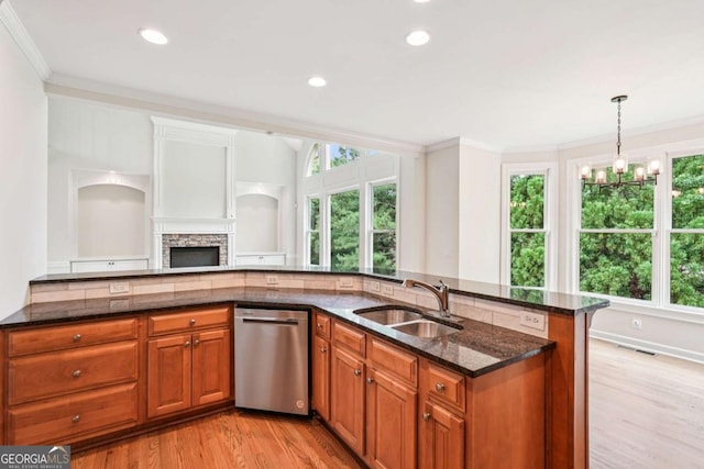 4508 Meadow Vista Trce, Lithonia, GA 30038 - kitchen with dishwasher, a sink, brown cabinetry, plenty of natural light, and ornamental molding