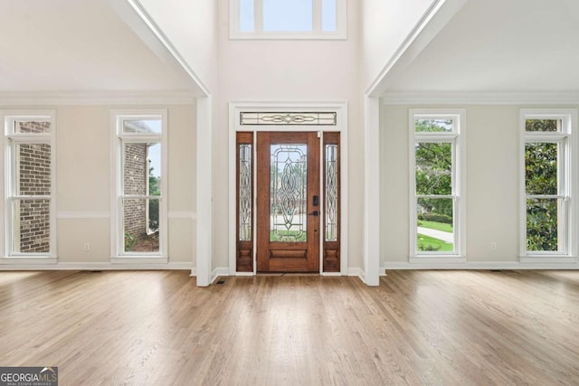 4508 Meadow Vista Trce, Lithonia, GA 30038 - foyer entrance with wood finished floors, a towering ceiling, baseboards, and crown molding