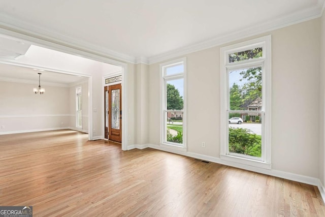 4508 Meadow Vista Trce, Lithonia, GA 30038 - unfurnished room with ornamental molding, a chandelier, light wood finished floors, and baseboards