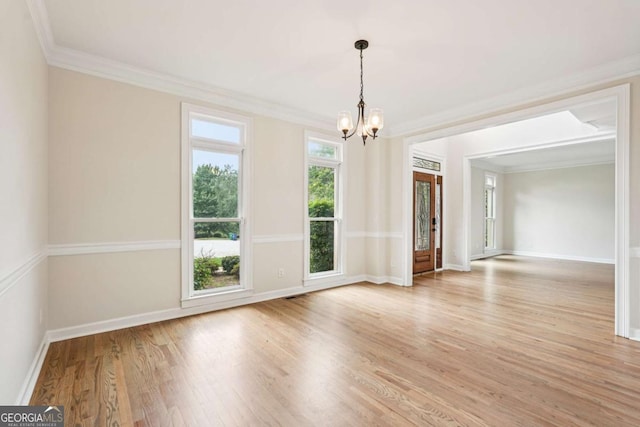4508 Meadow Vista Trce, Lithonia, GA 30038 - spare room featuring a chandelier, light wood-style flooring, crown molding, and baseboards