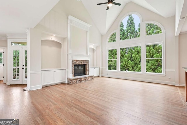 4508 Meadow Vista Trce, Lithonia, GA 30038 - unfurnished living room with a ceiling fan, light wood finished floors, a stone fireplace, high vaulted ceiling, and baseboards