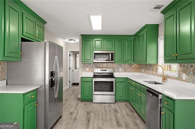 1071 N Price Rd, Sugar Hill, GA 30518 - kitchen featuring stainless steel appliances, light wood-style flooring, backsplash, and light countertops