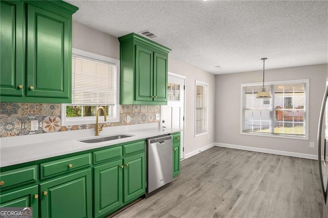 1071 N Price Rd, Sugar Hill, GA 30518 - kitchen with stainless steel dishwasher, decorative backsplash, light wood finished floors, a textured ceiling, and light countertops