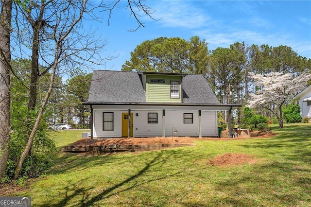 1071 N Price Rd, Sugar Hill, GA 30518 - view of front of house featuring a front lawn, roof with shingles, and covered porch