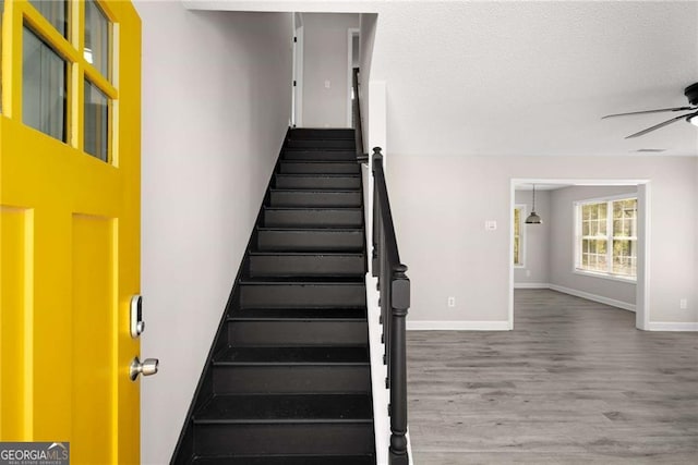 1071 N Price Rd, Sugar Hill, GA 30518 - stairway with ceiling fan and wood finished floors