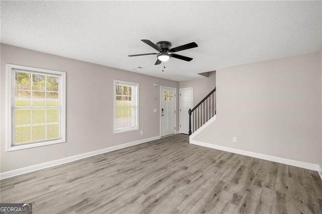 1071 N Price Rd, Sugar Hill, GA 30518 - entryway with wood finished floors, stairs, a ceiling fan, and a textured ceiling