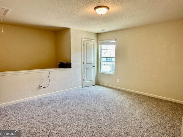 323 Morning Dr, Athens, GA 30606 - unfurnished room with attic access, a textured ceiling, and carpet