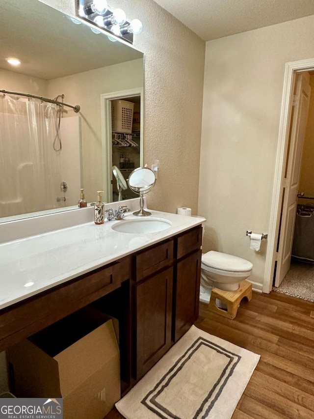 323 Morning Dr, Athens, GA 30606 - full bathroom featuring vanity, wood finished floors, and a textured wall