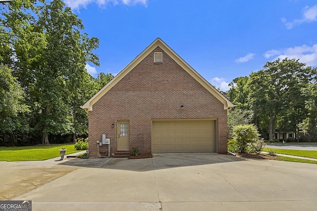 309 Cimarron Ct, Macon, GA 31220 - view of side of home with brick siding, concrete driveway, and a garage