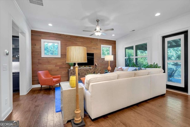 1099 Heyward Way, Alpharetta, GA 30009 - living room featuring wood walls, ceiling fan, wood finished floors, an accent wall, and recessed lighting