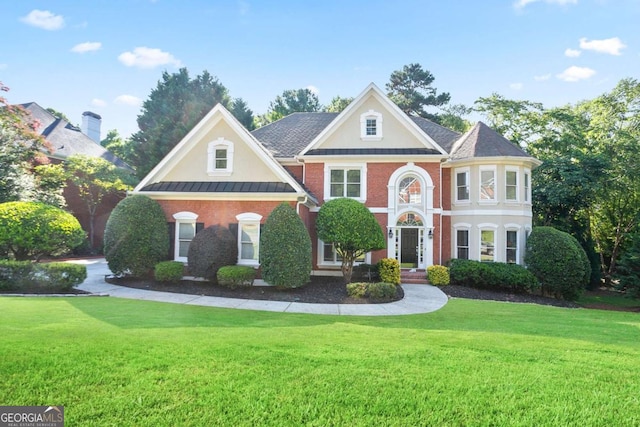 3741 Cape York Trce, Alpharetta, GA 30022 - colonial-style house featuring a front yard, a standing seam roof, brick siding, stucco siding, and a metal roof