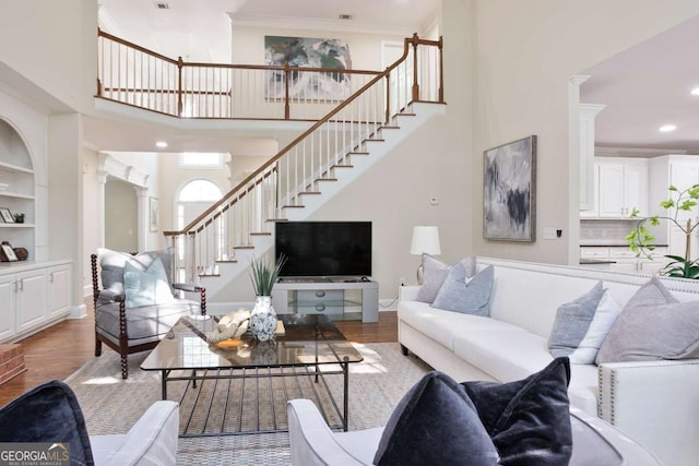 3741 Cape York Trce, Alpharetta, GA 30022 - living room featuring stairway, decorative columns, wood finished floors, recessed lighting, and ornamental molding